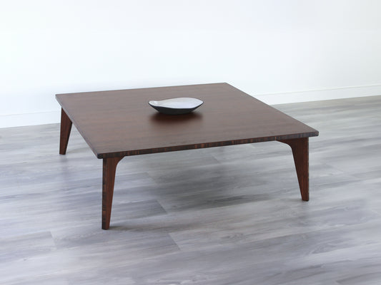 Large square floor table in bamboo with a walnut color finish, featuring a Japandi style design, set on a grey floor with a white background. A small black pottery vessel sets on top.

Square low table 
japanese furniture
japanese low table
low coffee table
low dining table
low table
mid century
minimalist
minimalist table
modern
chabudai