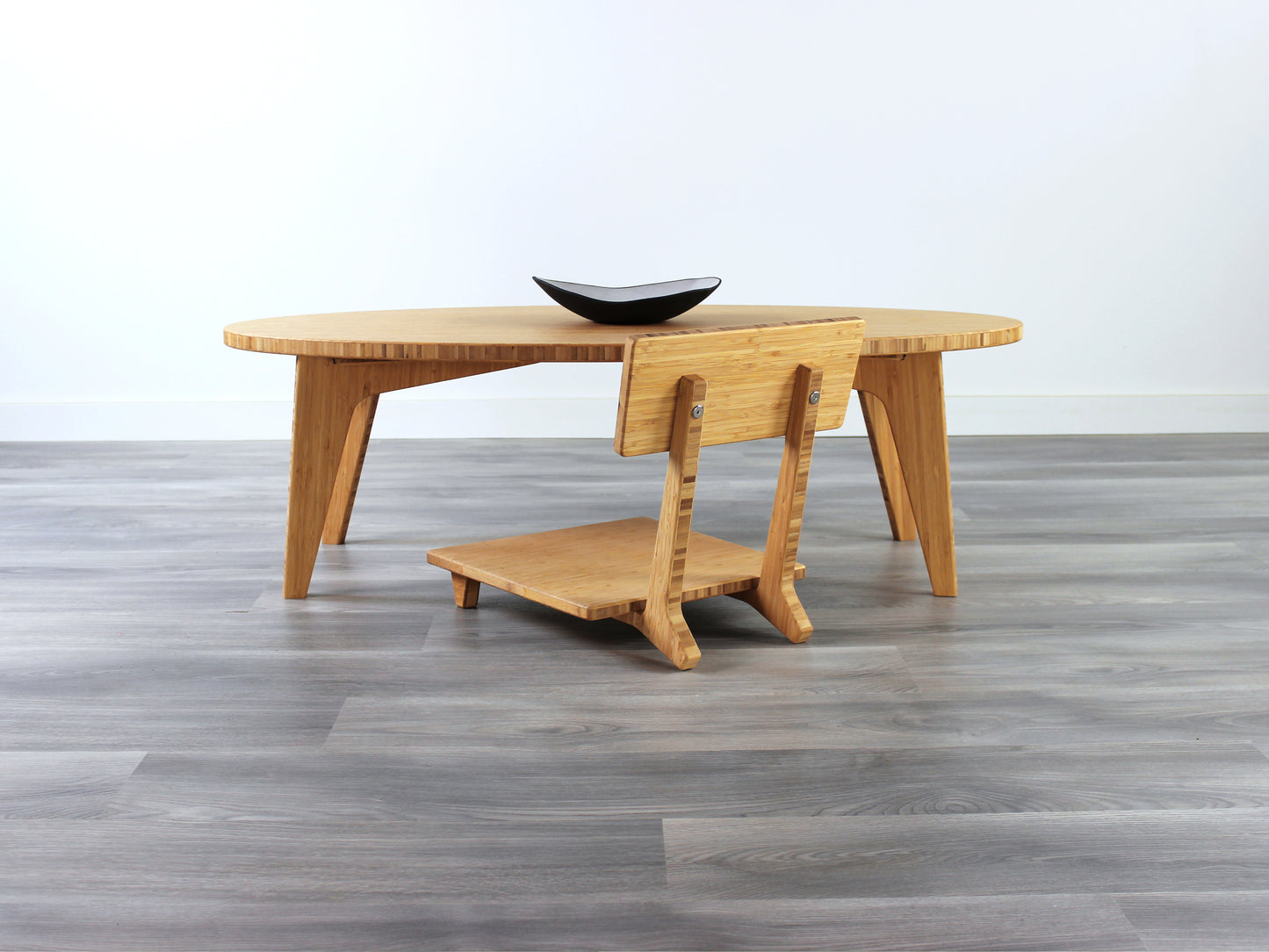 Oval LOW Table set with a natural bamboo finish and midcentury modern design. A Floor Chair Comfort is set at the table. Small black pottery vessel placed on table top. 

Japandi, minimalist, mid-century, Japanese inspired, modern, contemporary, clean lines, organic design, sustainable bamboo, renewable bamboo, solid bamboo, eco-friendly furniture, natural materials, natural-based finish