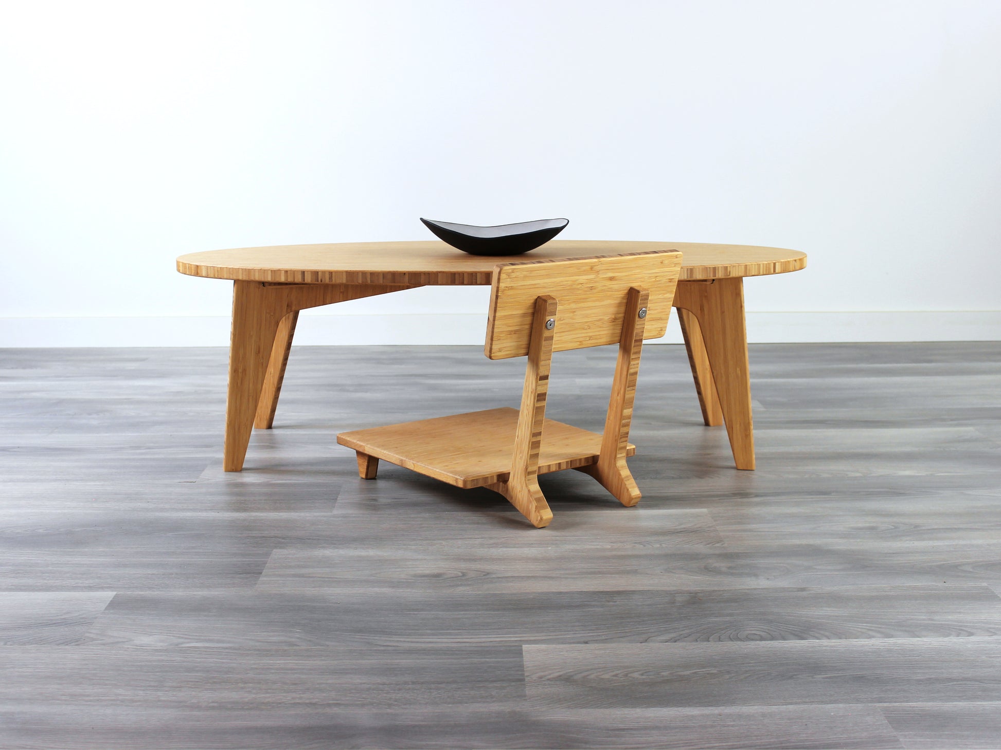 Oval LOW Table set with a natural bamboo finish and midcentury modern design. A Floor Chair Comfort is set at the table. Small black pottery vessel placed on table top. 

Japandi, minimalist, mid-century, Japanese inspired, modern, contemporary, clean lines, organic design, sustainable bamboo, renewable bamboo, solid bamboo, eco-friendly furniture, natural materials, natural-based finish