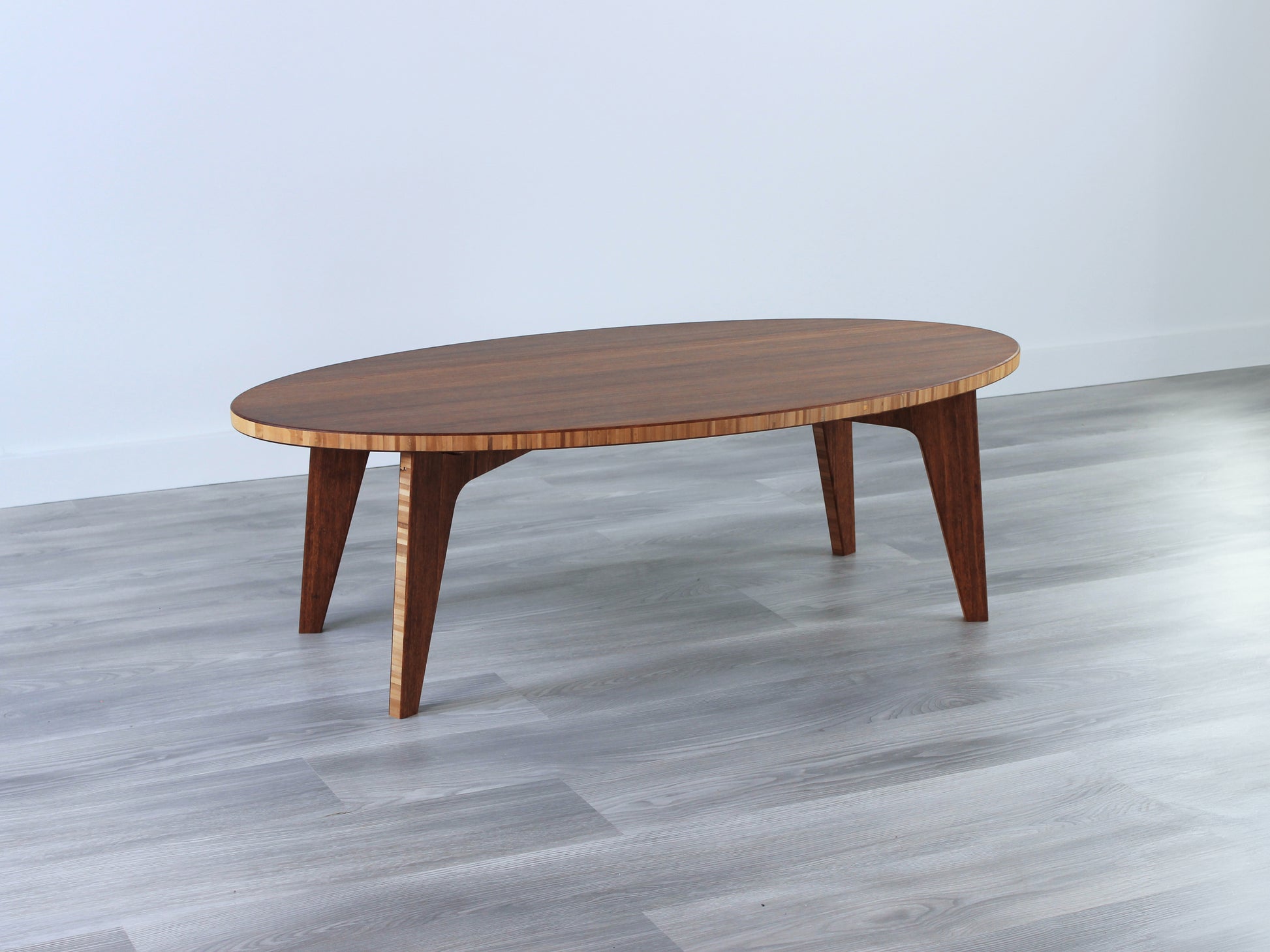 Oval bamboo table with a chestnut color finish, featuring a Japandi style design, set on a grey floor with a white background.

mid century modern low table
midcentury modern coffee table
floor table
japan coffee table
japan furniture
japan table
bamboo low table