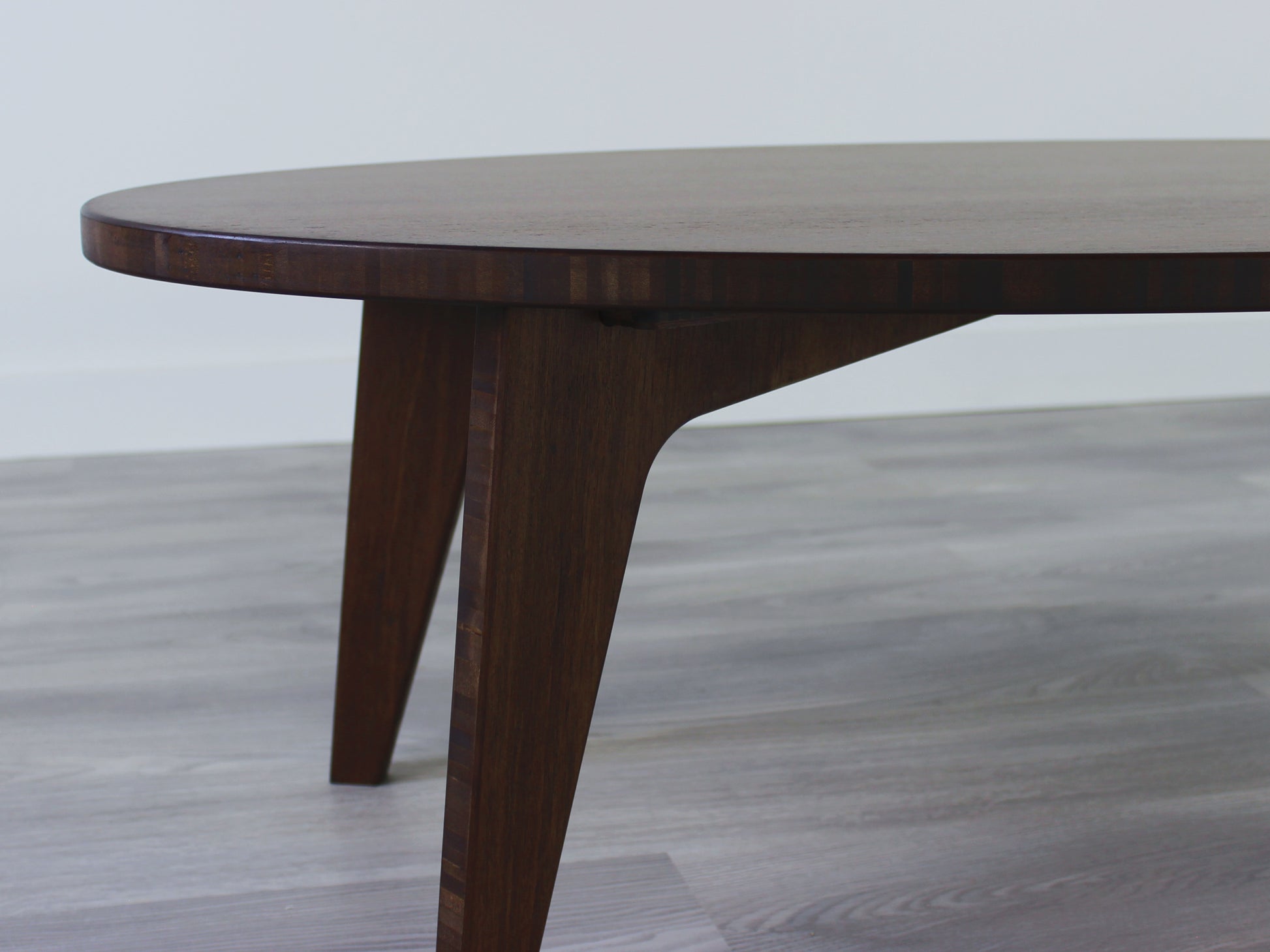 Oval bamboo table with a walnut color finish, featuring a Japandi style design, set on a grey floor with a white background. 

mid century modern low table
midcentury modern coffee table
floor table
japan coffee table
japan furniture
japan table
oval coffee table 
bamboo low table