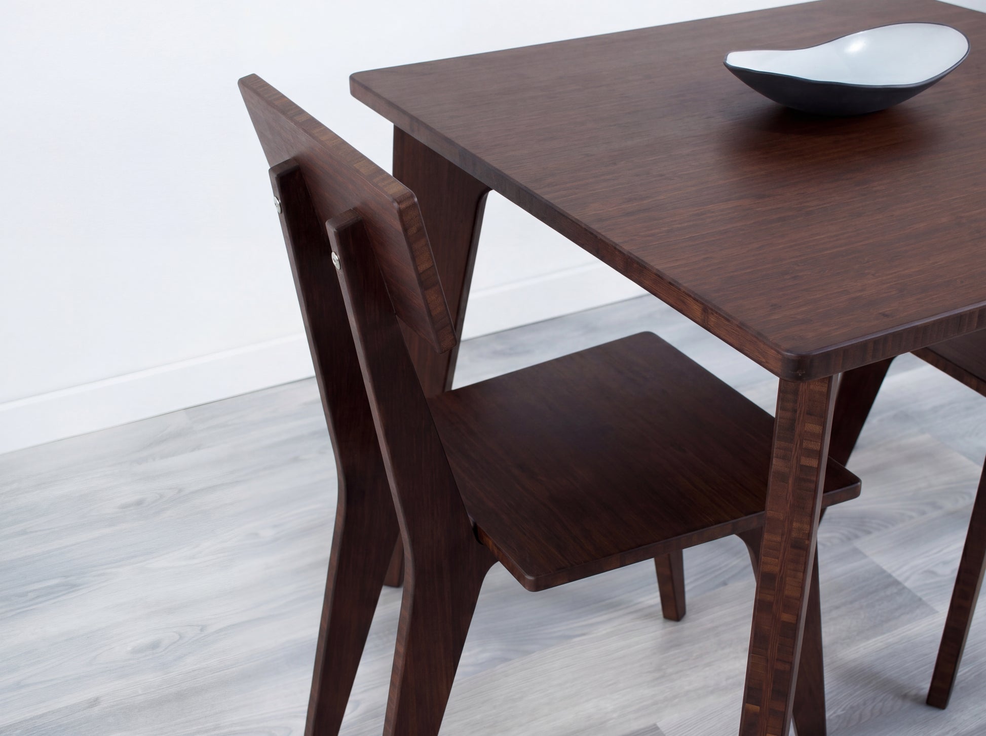 Bamboo dining table with chair on a light wooden floor