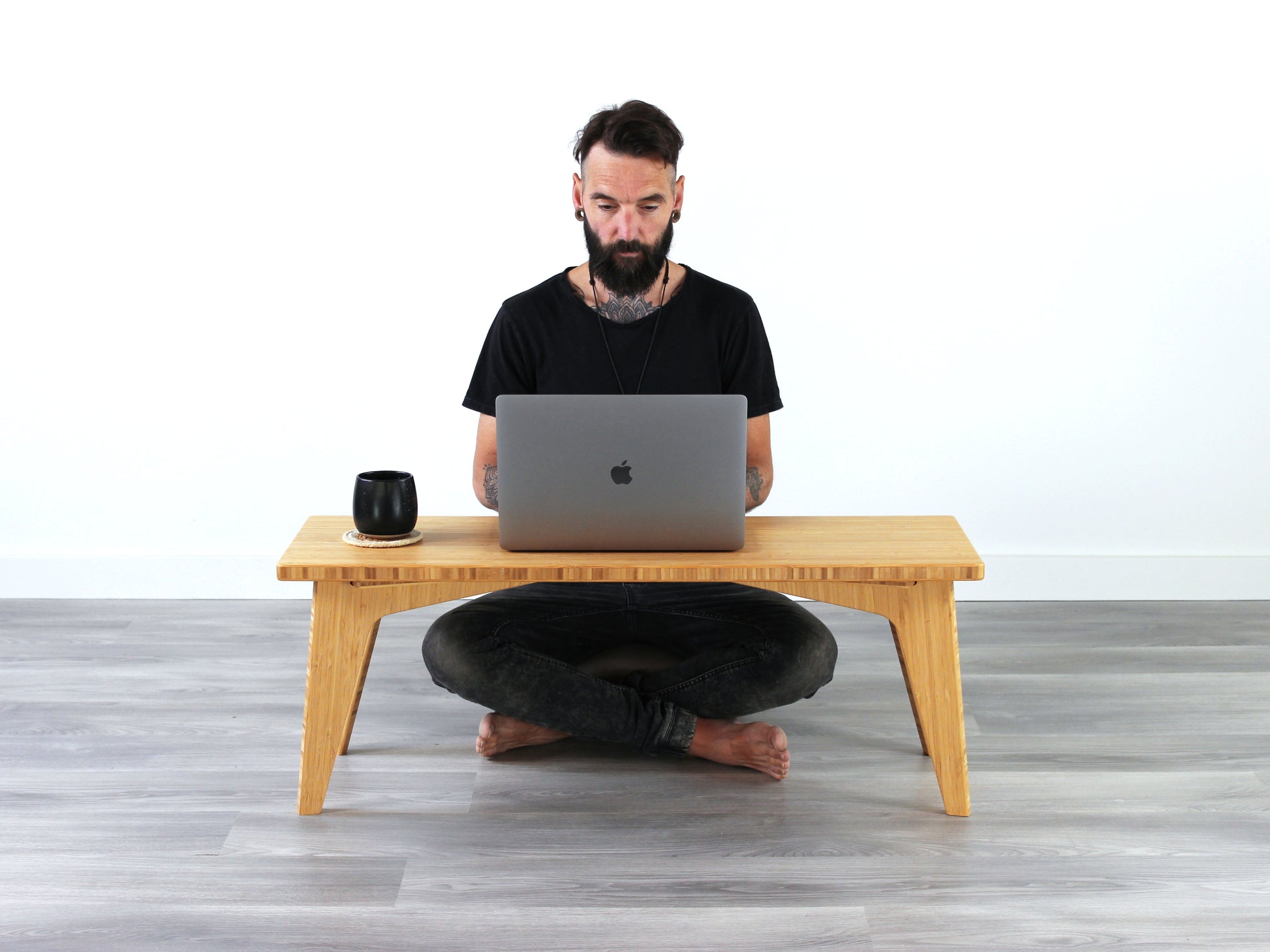 Person sitting cross legged at Small Floor Desk working on a laptop. A black coffee mug is on the table top.

low desk
modern design 
rectangle low desk
japanese low desk 
ergonomic 
minimilist 