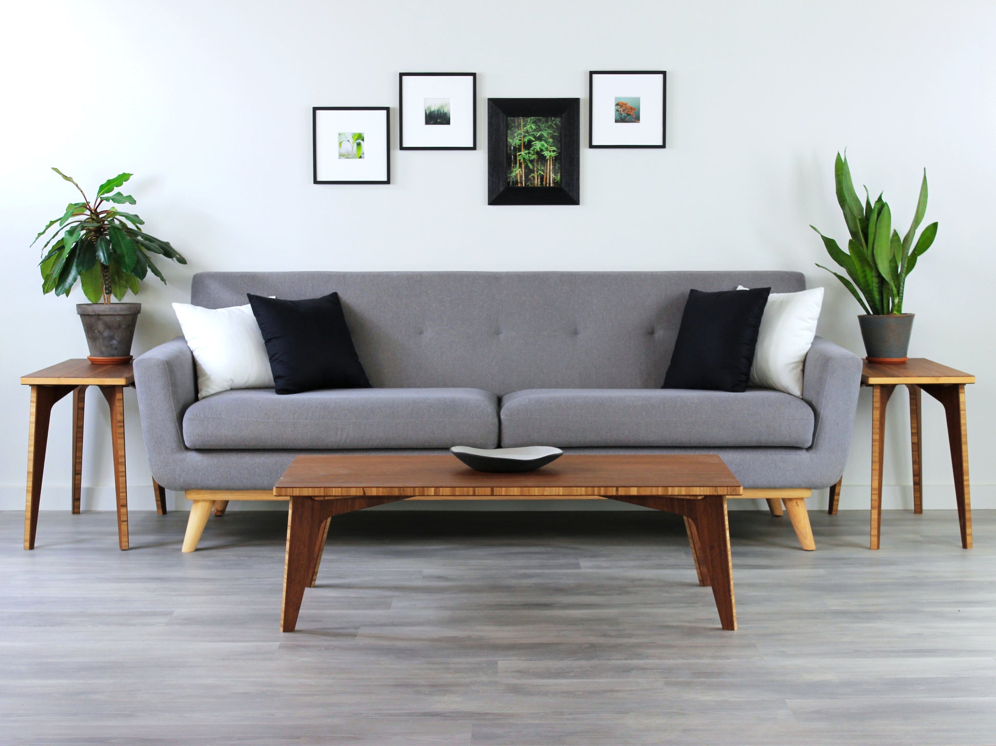 A small rectangular low table made of bamboo with a natural finish, placed on a grey floor with a white background. Set in a living room area, a grey couch and side tables with houseplants. A small black pottery vessel is placed on the table top. 

japanese furniture
japanese low table
low coffee table
low dining table
low table
mid century
minimalist
minimalist table
modern
chabudai
