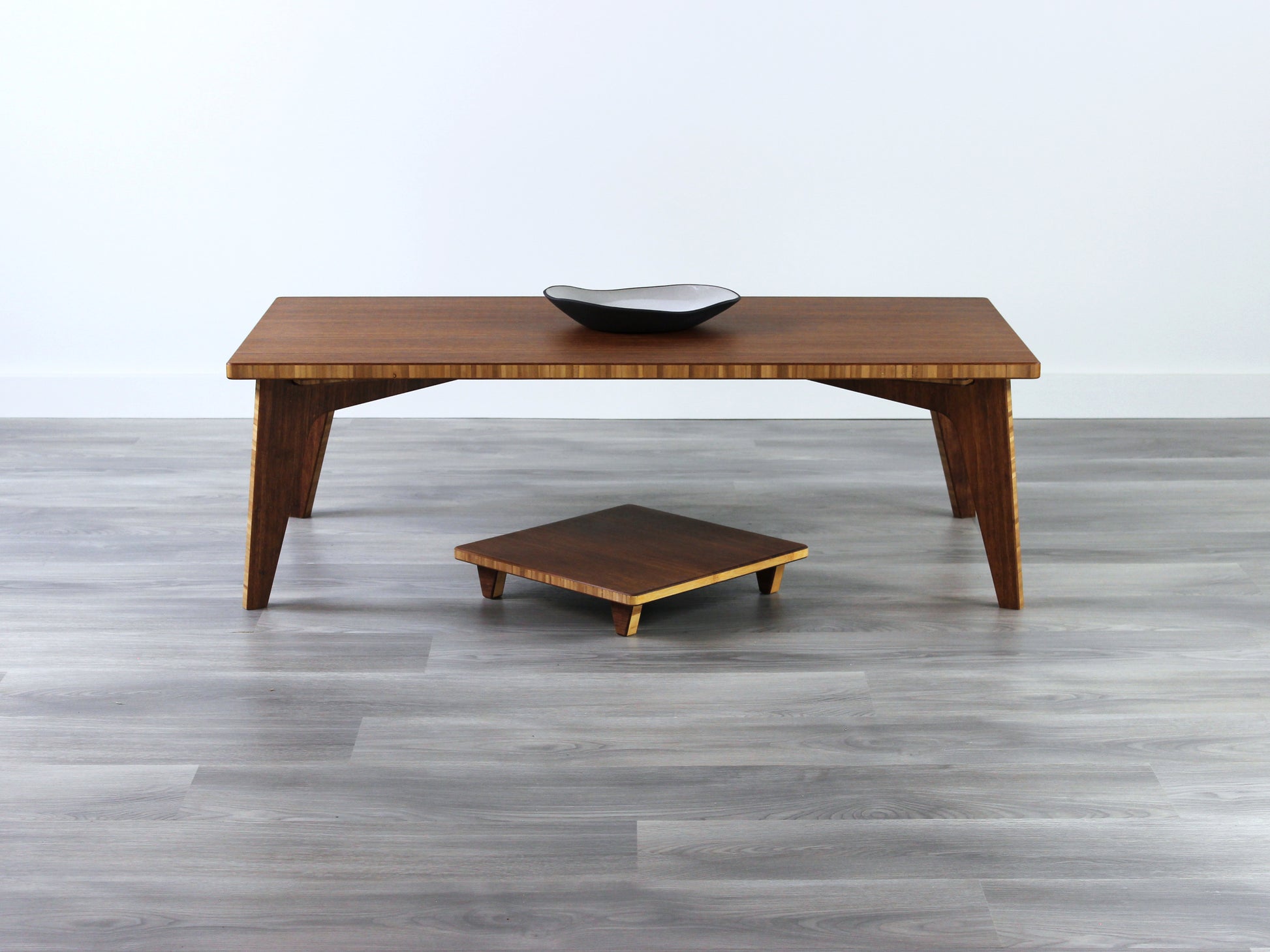 Small Rectangle Table Set - Chestnut, low table with Floor Chair Posture set underneath. Set on a grey floor, against a white background. A small black pottery vessel is on the table top. 

low table, coffee table, dining table, floor desk, floor chair, floor seating, low dining table, chabudai, tatami, kotatsu, minimalist, minimalist table,
modernn