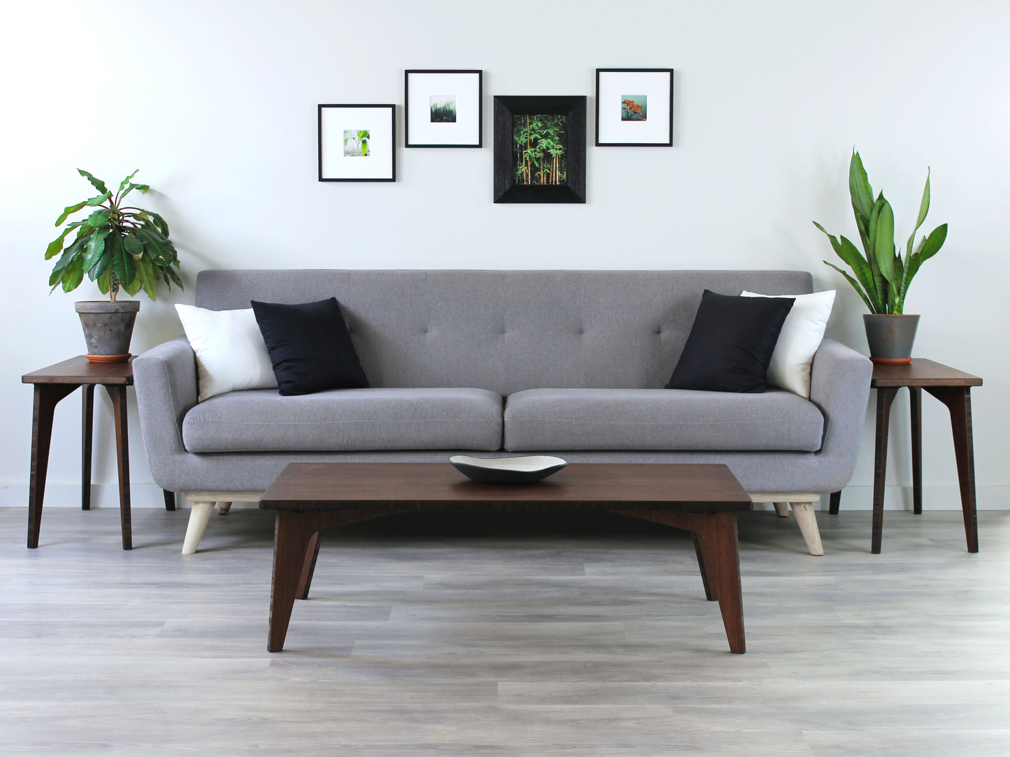 A rectangular low table made of bamboo with a walnut finish, placed on a grey floor, designed for multi-functional use in living spaces. Small black pottery vessel on table top. Set in a living room setting with a grey couch and two Side Tables with houseplants. 

japanese furniture
japanese low table
low coffee table
low dining table
low table
mid century
minimalist
minimalist table
modern