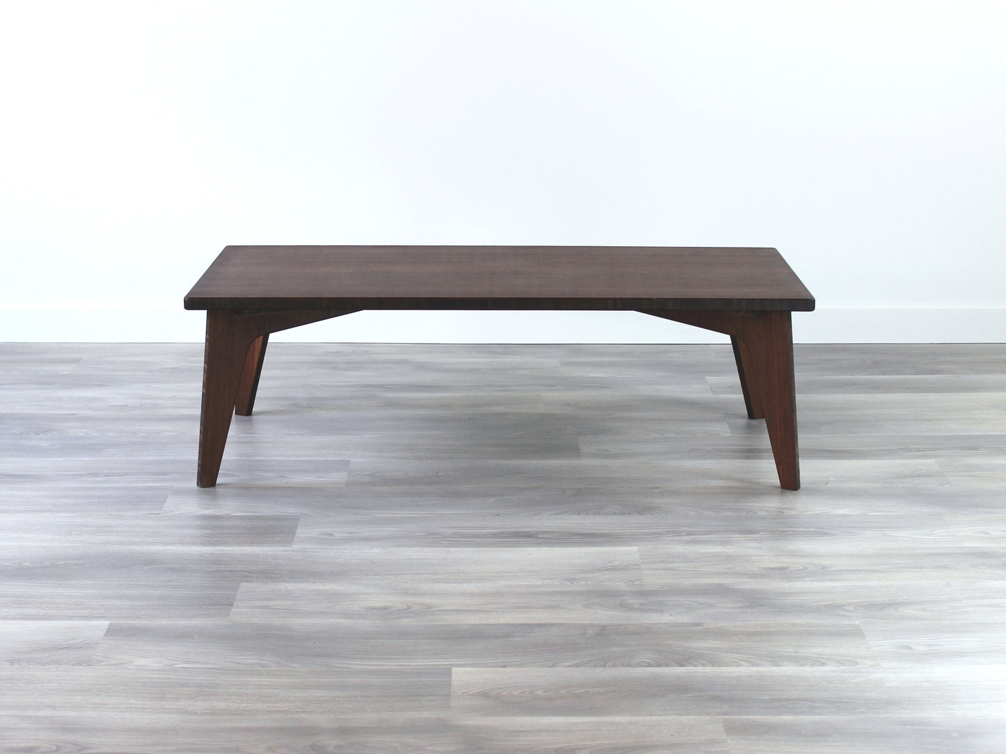 A rectangular low table made of bamboo with a walnut finish, placed on a grey floor, designed for multi-functional use in living spaces.  

japanese furniture
japanese low table
low coffee table
low dining table
low table
mid century
minimalist
minimalist table
modern