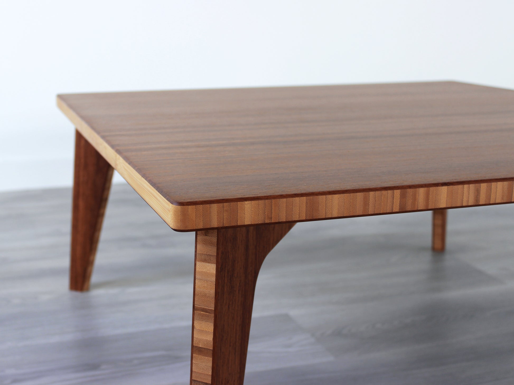 Small Square Table with chestnut bamboo finish. Grey flooring with a white background. 

mid century modern low table
midcentury modern coffee table
floor table
japan coffee table
japan furniture
japan table
small coffee table 
bamboo low table