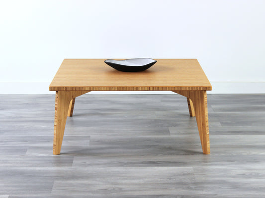 Small Square Table with natural bamboo finish, featuring a small black and white pottery vessel placed on top. Grey flooring with a white background. 

mid century modern low table
midcentury modern coffee table
floor table
japan coffee table
japan furniture
japan table
small coffee table 
bamboo low table