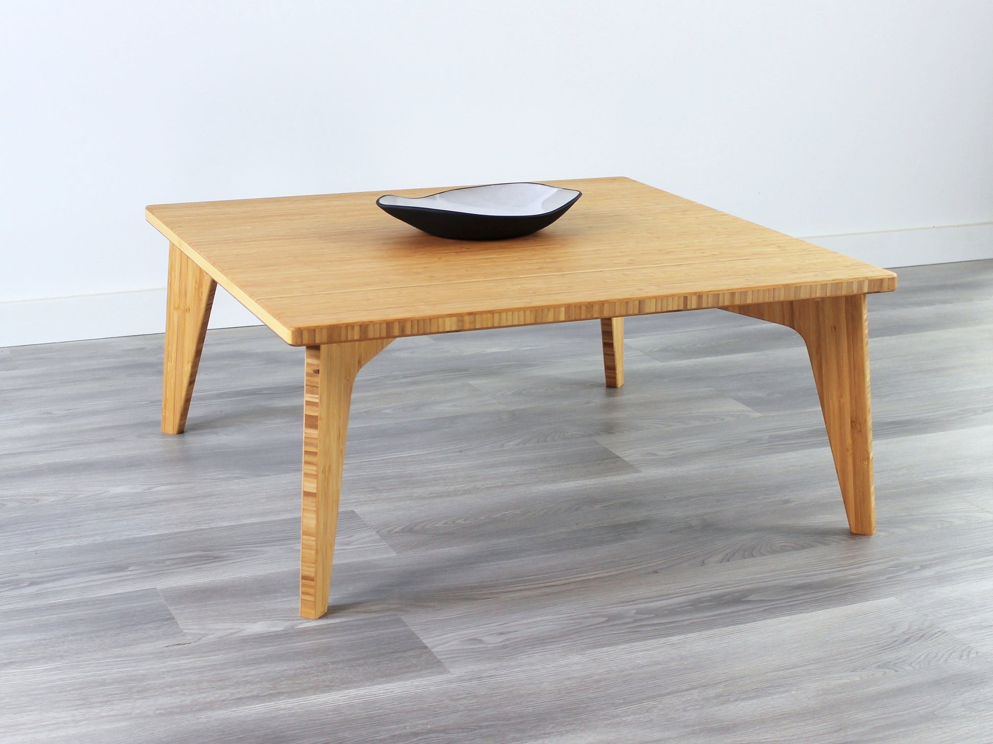 Small Square Table with natural bamboo finish, featuring a small black and white pottery vessel placed on top. Grey flooring with a white background. 

mid century modern low table
midcentury modern coffee table
floor table
japan coffee table
japan furniture
japan table
small coffee table 
bamboo low table