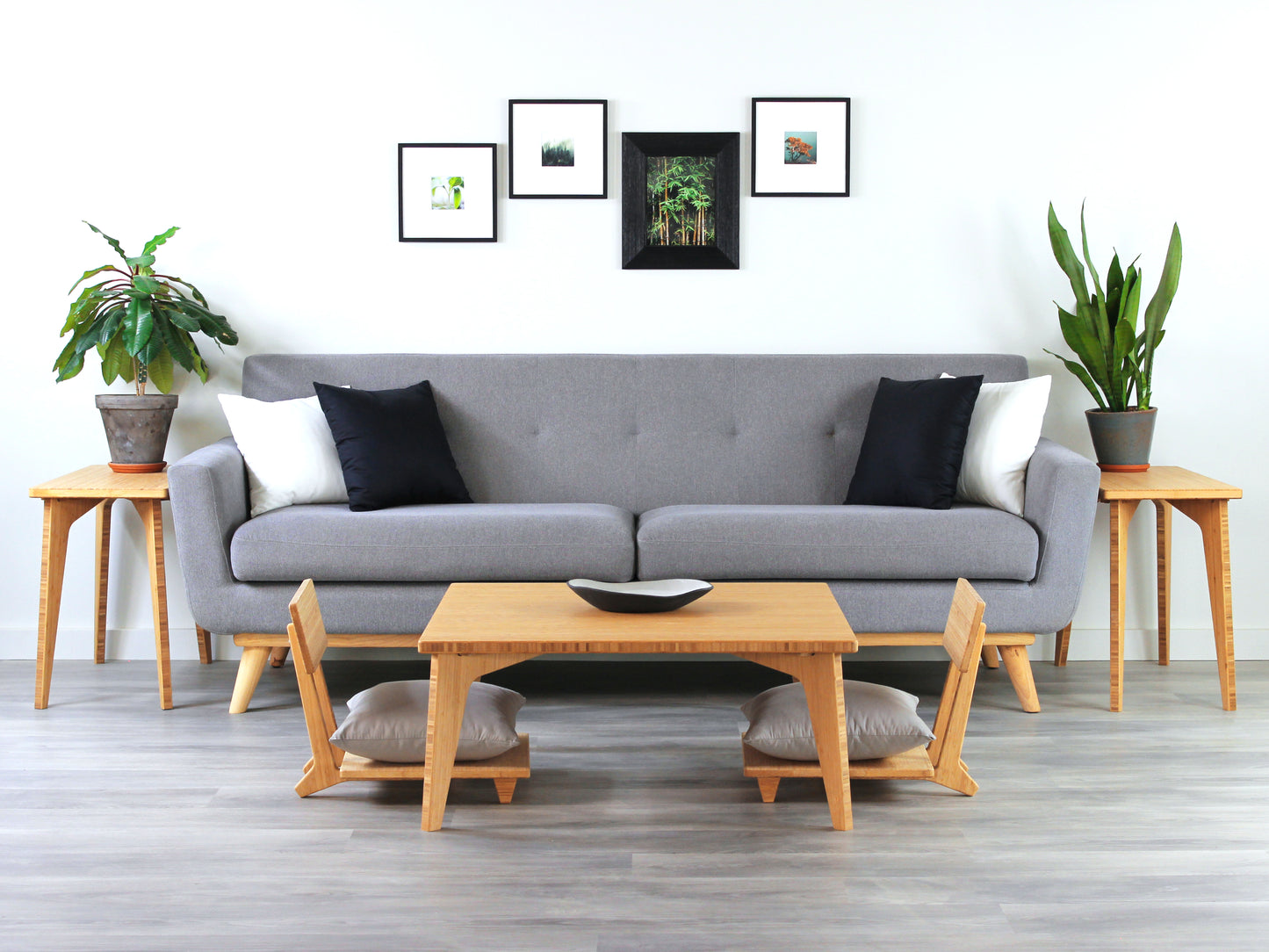 Small Square Table Set in natural finish. Two Floor Chair Comfort with grey pillows are placed below. A small black pottery vessel is placed on top of the table. 

sustainable bamboo, renewable bamboo, solid bamboo, eco-friendly furniture, zero-waste, carbon neutral, natural materials, natural-based finish, repairable furniture