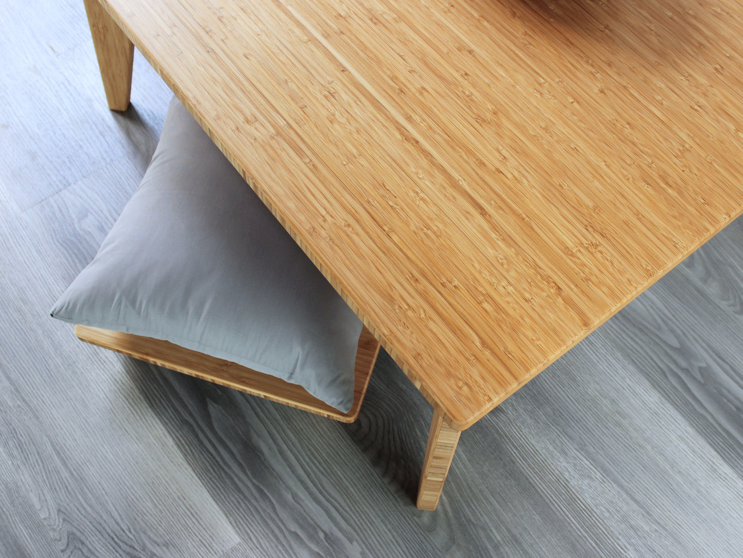 Small Square Table Set in natural finish. A Floor Chair Posture with grey pillows are placed below. 

sustainable bamboo, renewable bamboo, solid bamboo, eco-friendly furniture, zero-waste, carbon neutral, natural materials, natural-based finish, repairable furniture