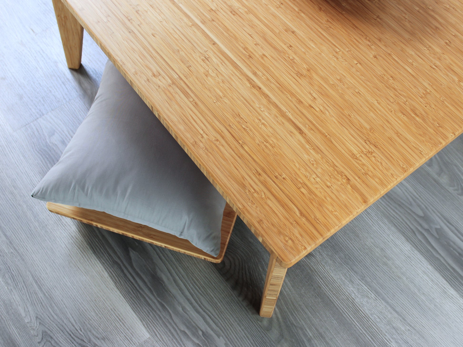Small Square Table Set in natural finish. A Floor Chair Posture with grey pillows are placed below. 

sustainable bamboo, renewable bamboo, solid bamboo, eco-friendly furniture, zero-waste, carbon neutral, natural materials, natural-based finish, repairable furniture