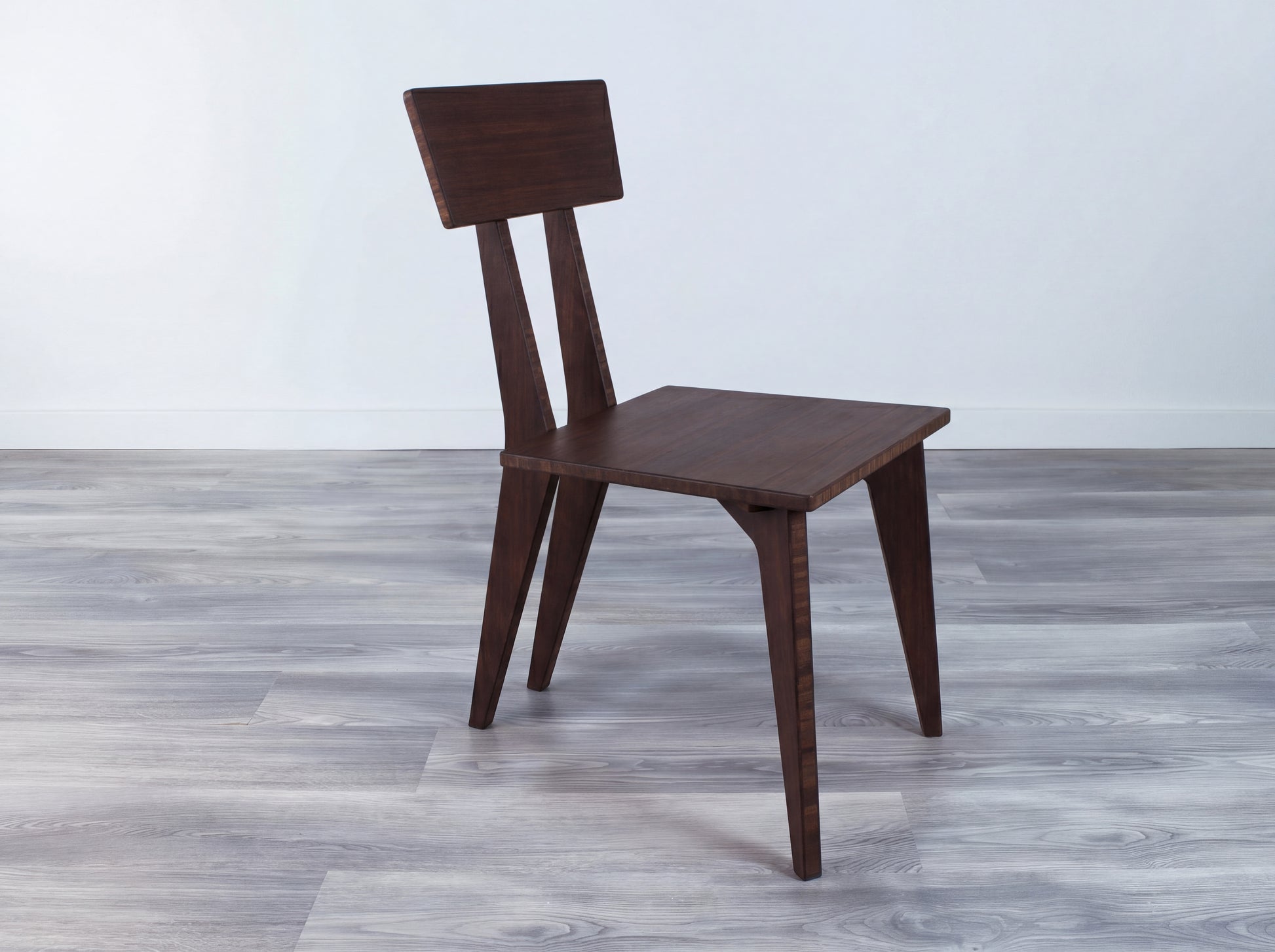 Bamboo walnut dining chair on gray floor with white wall background