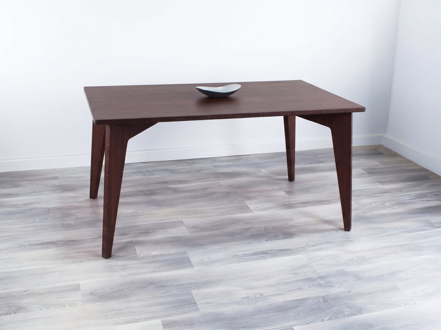 walnut bamboo dining table with black bowl on top seats up to 6 chairs