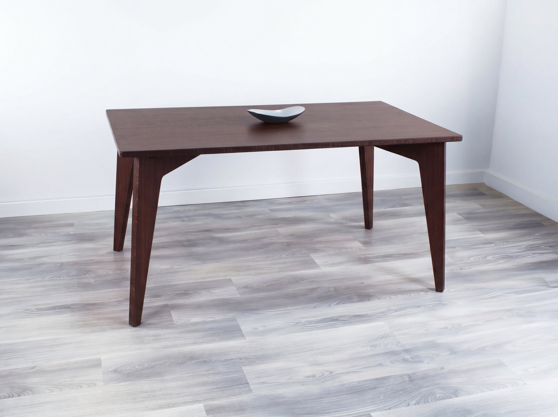 walnut bamboo dining table with black bowl on top seats up to 6 chairs