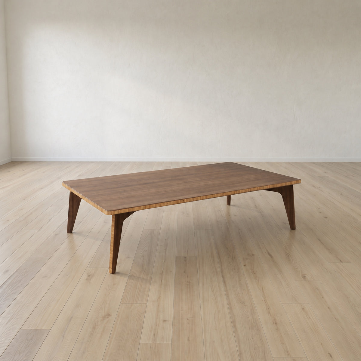 A large dark finish Japanese low bamboo table in a big open space with soft lighting.