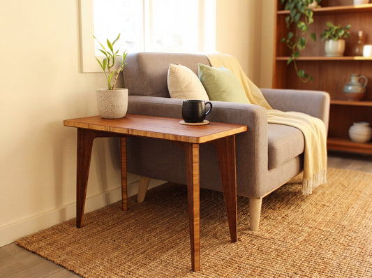 Cozy living room with a gray sofa, bamboo side table, and decorative items.

mid century
minimalist
side table
bamboo
