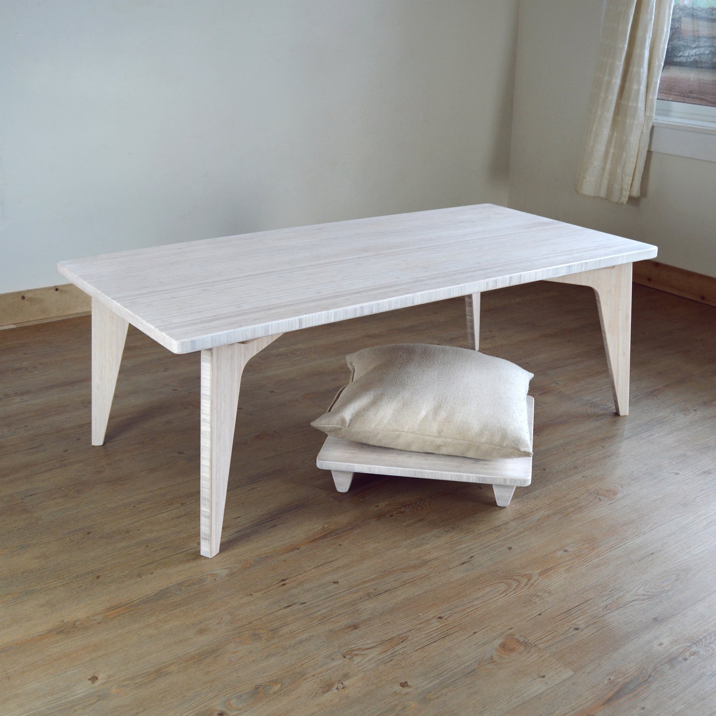 Natural bamboo pillow lift in white with table. Japanese, mid-century, Scandinavian and contemporary inspired. Sustainable wood alternative, made from solid grass.