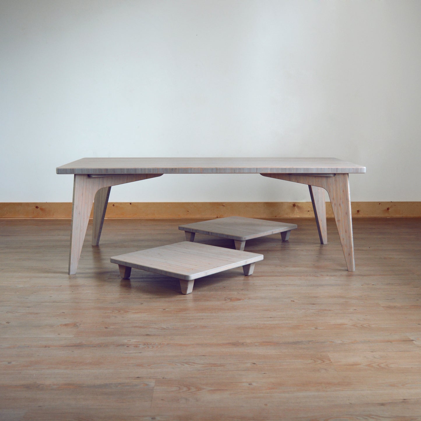 Grey bamboo table with pillow lifts. Japanese, mid-century, Scandinavian and contemporary inspired. Sustainable wood alternative, made from solid grass.